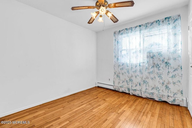 empty room featuring baseboards, ceiling fan, and light wood finished floors