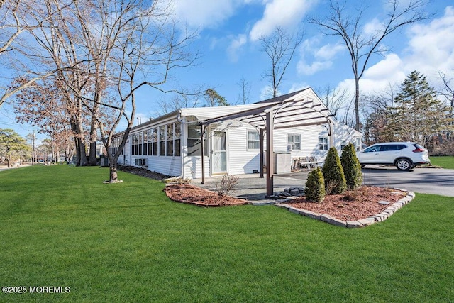 view of side of home featuring a yard and driveway