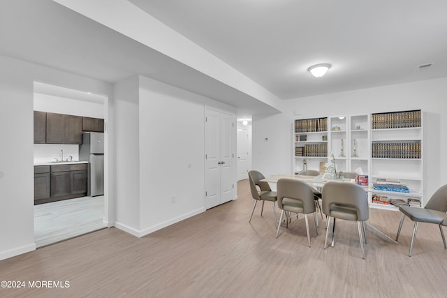 dining room with sink and light hardwood / wood-style floors