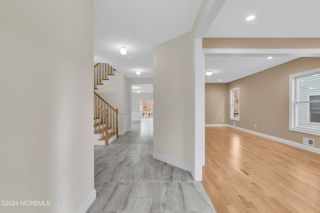 hallway with light hardwood / wood-style floors