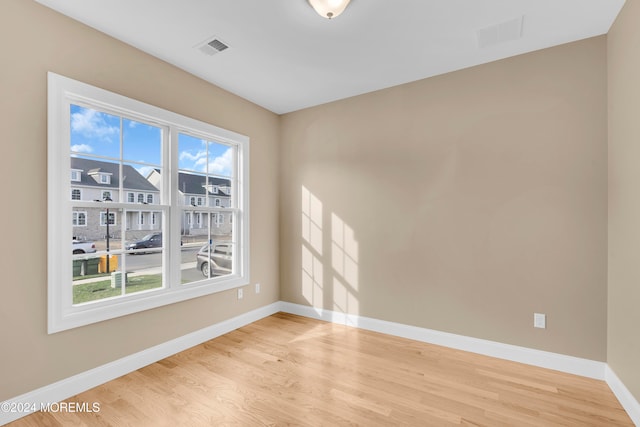 unfurnished room with light wood-type flooring