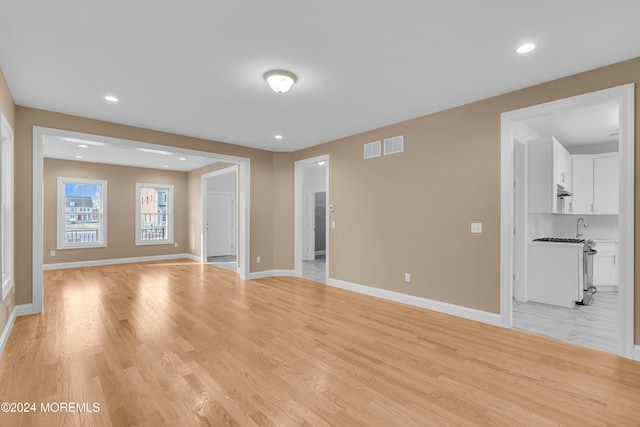 unfurnished living room featuring light wood-type flooring