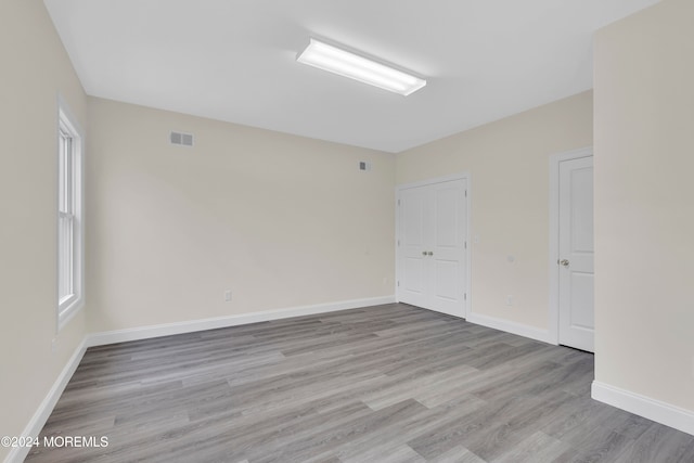 empty room with light hardwood / wood-style flooring