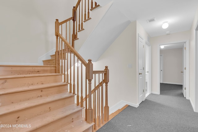 stairs featuring carpet floors