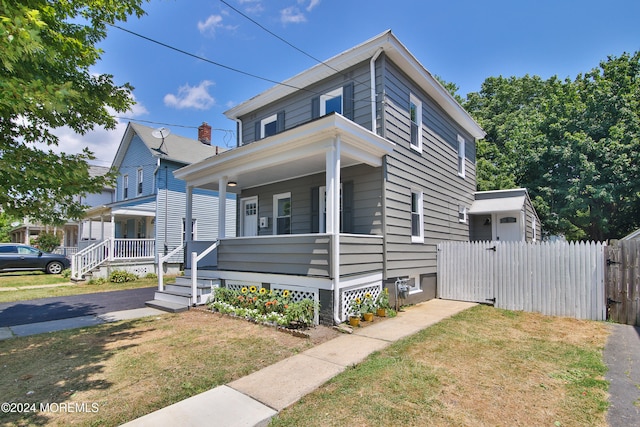 view of front of house with a porch and a front lawn