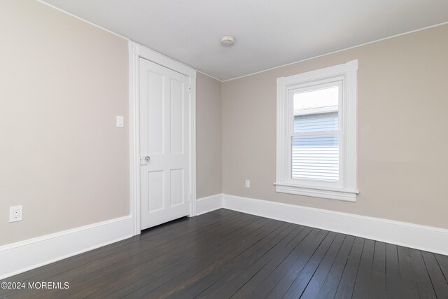 spare room featuring dark hardwood / wood-style flooring