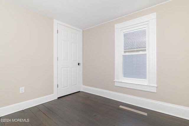 spare room featuring dark hardwood / wood-style floors