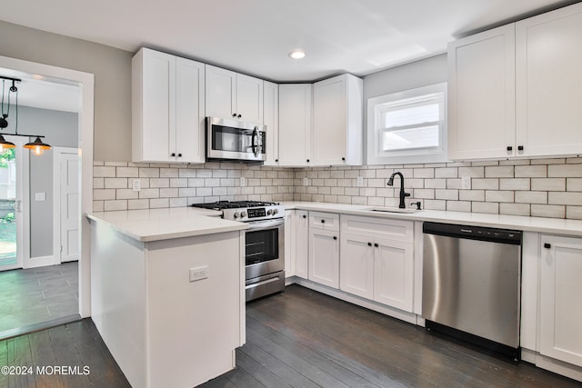 kitchen featuring white cabinetry, sink, appliances with stainless steel finishes, and dark wood-type flooring