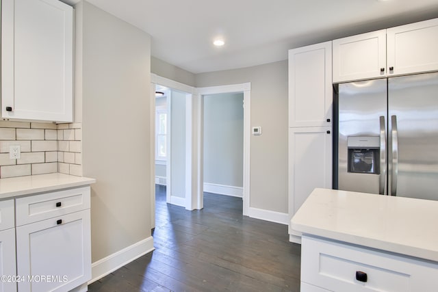 kitchen with white cabinets, backsplash, stainless steel refrigerator with ice dispenser, and dark wood-type flooring