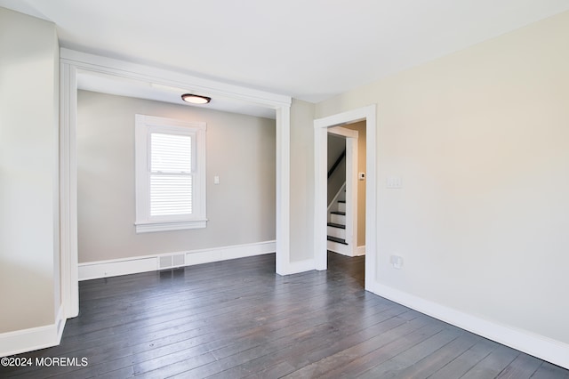 unfurnished room featuring dark hardwood / wood-style floors