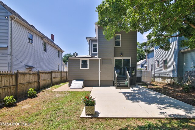 back of property featuring a yard and a patio