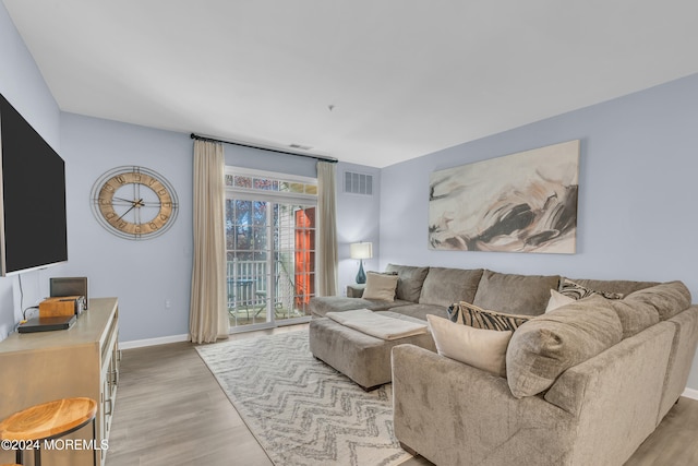 living room with light hardwood / wood-style flooring