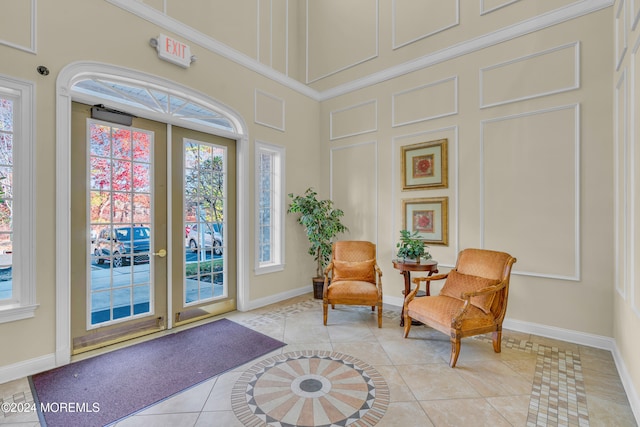 living area featuring french doors and light tile patterned floors