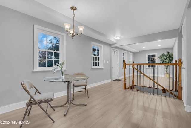 dining area featuring an inviting chandelier and light wood-type flooring