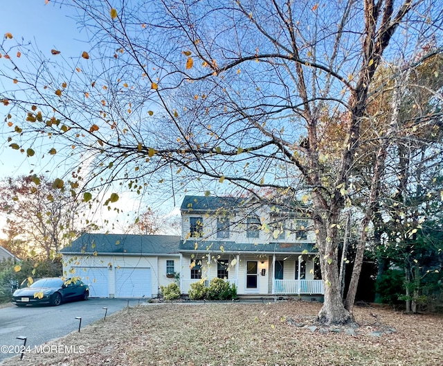 view of front facade featuring a garage and covered porch