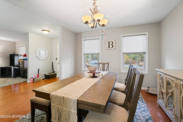 dining room featuring an inviting chandelier and dark wood-type flooring