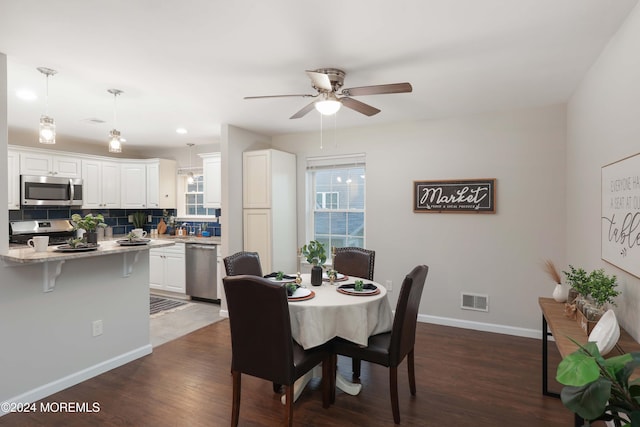 dining area featuring ceiling fan and dark hardwood / wood-style flooring