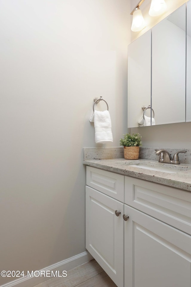 bathroom featuring hardwood / wood-style flooring and vanity