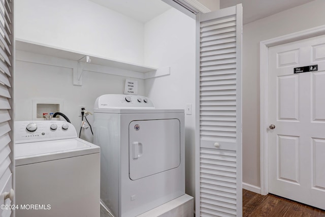 washroom with independent washer and dryer and dark wood-type flooring