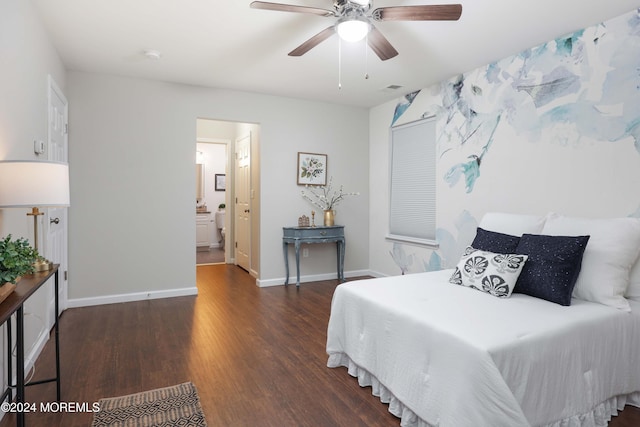 bedroom with ceiling fan, ensuite bathroom, and dark wood-type flooring