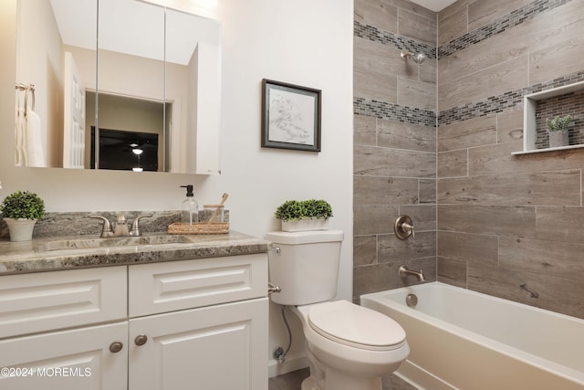 full bathroom featuring vanity, toilet, and tiled shower / bath