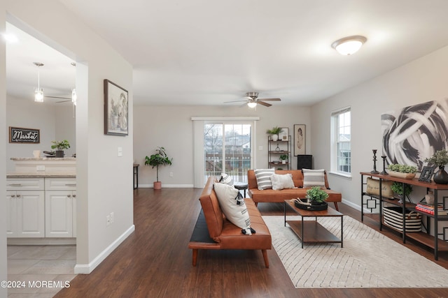 living room with ceiling fan, plenty of natural light, and hardwood / wood-style floors