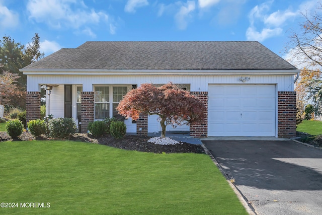 view of front of house with a garage and a front yard