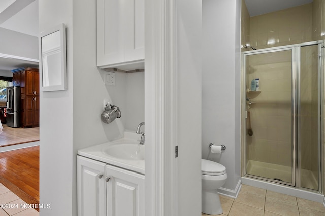 bathroom with vanity, hardwood / wood-style flooring, toilet, and walk in shower