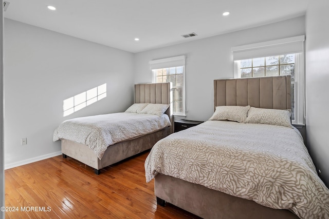 bedroom with hardwood / wood-style flooring