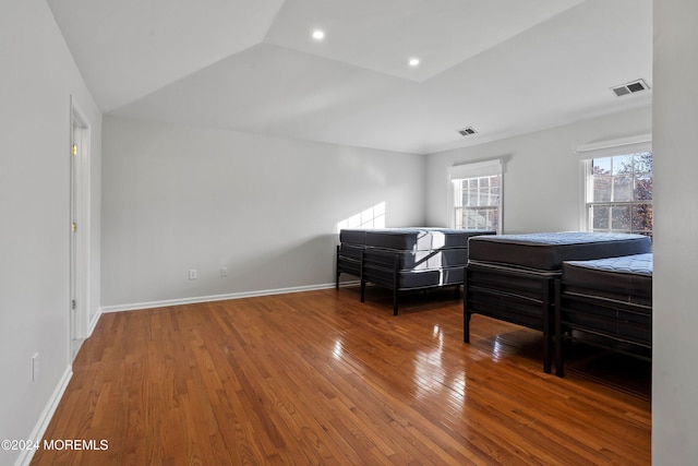 bedroom with hardwood / wood-style floors and vaulted ceiling