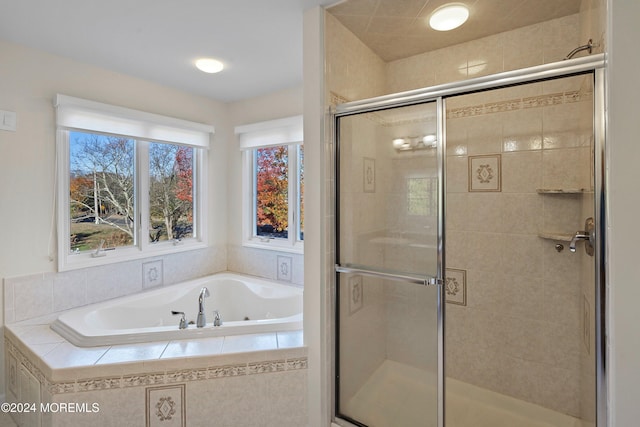 bathroom featuring separate shower and tub