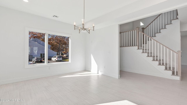 spare room with a chandelier