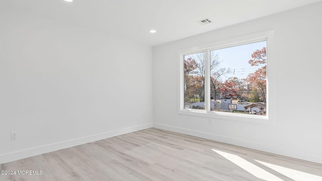 unfurnished room featuring light hardwood / wood-style floors