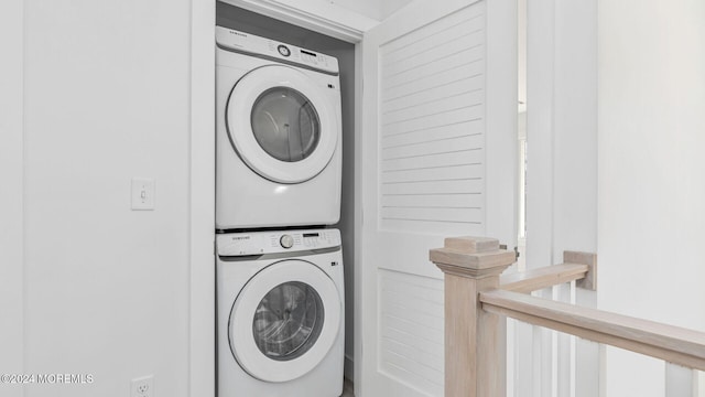 clothes washing area featuring stacked washing maching and dryer