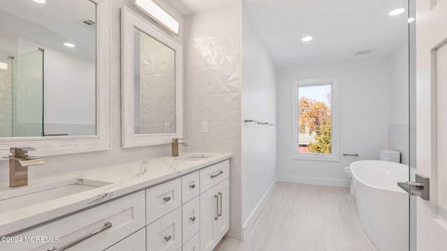 bathroom with vanity and a bathing tub