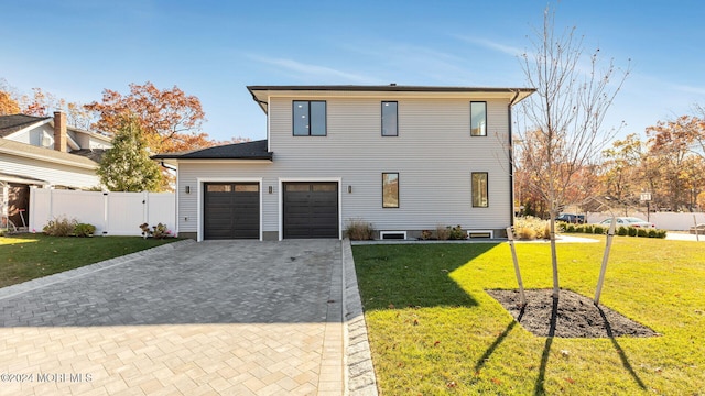 view of front property with a front yard and a garage