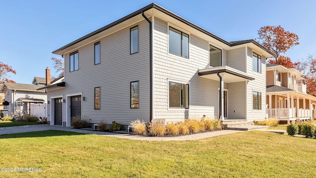 view of front of home featuring a garage and a front lawn