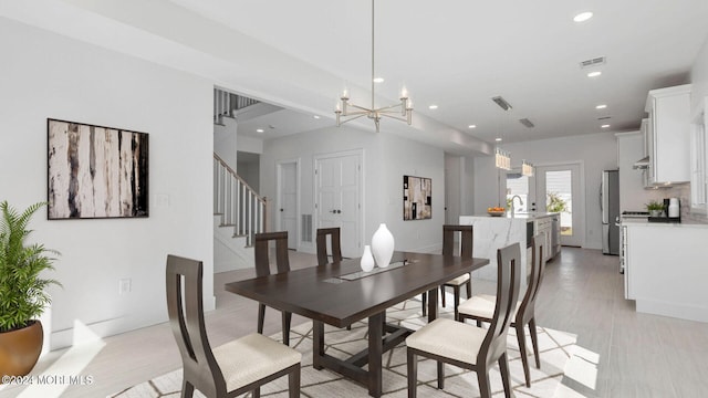 dining room featuring an inviting chandelier and sink