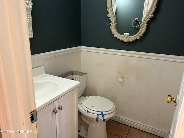 bathroom featuring tile patterned flooring, vanity, and toilet