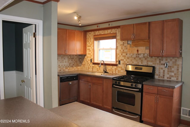 kitchen featuring appliances with stainless steel finishes, tasteful backsplash, crown molding, and sink