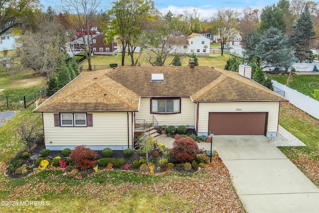 single story home featuring a front yard and a garage