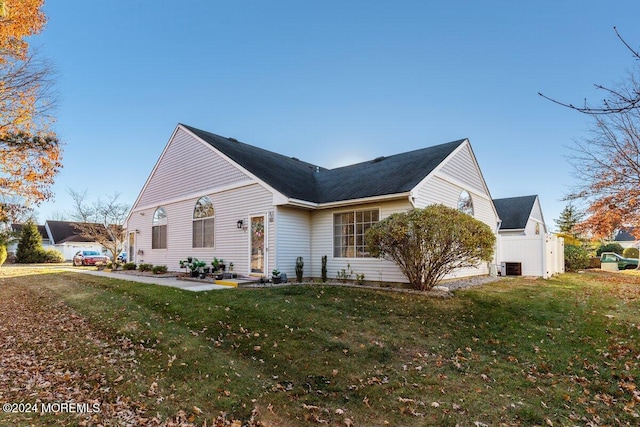 view of side of home with a yard and cooling unit