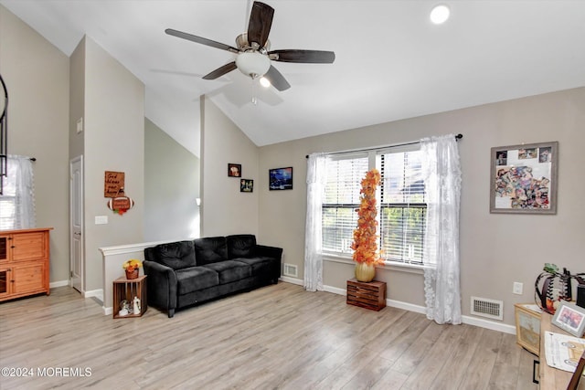 living area with ceiling fan, light wood-type flooring, and vaulted ceiling