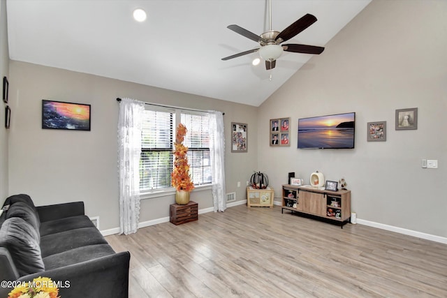 living room with ceiling fan, light hardwood / wood-style flooring, and high vaulted ceiling