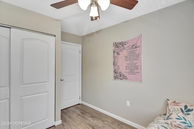 unfurnished bedroom featuring ceiling fan, light wood-type flooring, and a closet