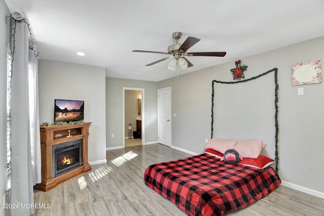 bedroom featuring hardwood / wood-style flooring, ceiling fan, and ensuite bathroom