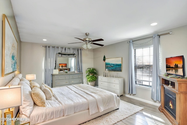 bedroom featuring ceiling fan and light hardwood / wood-style flooring