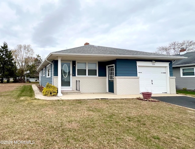 view of front of property featuring a garage and a front lawn