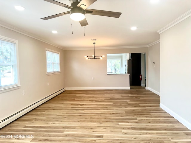 unfurnished room with light hardwood / wood-style flooring, a wealth of natural light, and a baseboard heating unit