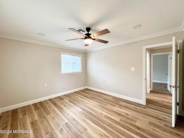 empty room with crown molding, ceiling fan, and light hardwood / wood-style floors